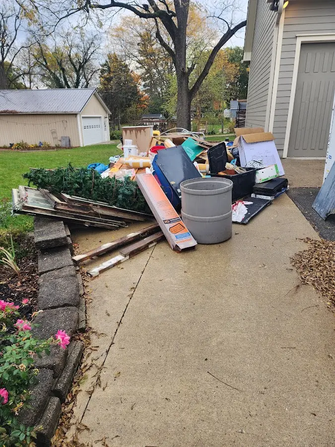 Dumpster being loaded with debris for Estate Cleanout Dumpster Rental in Deer Park